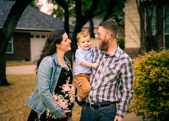 Young family in front of home