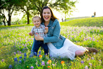 Fototapeta premium Mother and Son in Meadow of Flowers