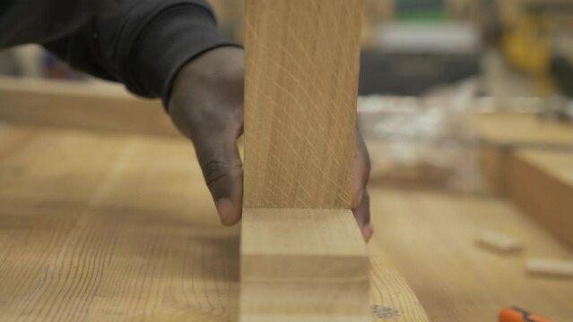Carpenter dry-fitting oak joint with dominos bespoke furniture Close up