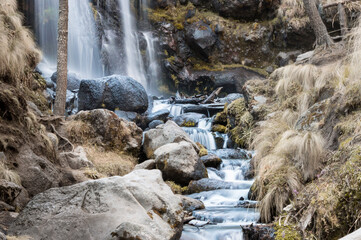 beautiful waterfall in the forest on an autumn day