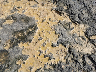 Coast of the Mediterranean Sea, long frozen lava. Background. It looks like an alien landscape.