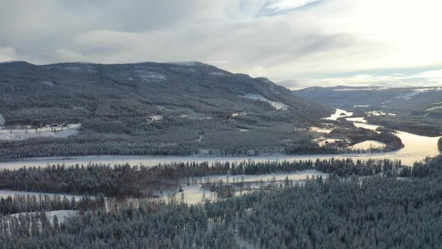 High drone shot of the river "Glomma" in Stor Elvdal, near the town of Atna, Norway. Slow pan left to right. 4k.