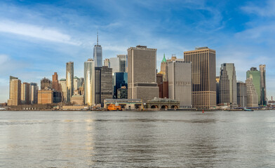 Fototapeta premium View of lower Manhattan with skyscrapers blue cloudy sky