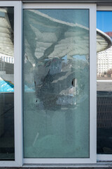 Broken glass door in shopping mall. Vandalism, burglary concept. Insurance concept.