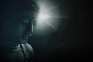 Asian buddha face enlightening wisdom with peace and calm bright light on darkness background. - obrazy, fototapety, plakaty