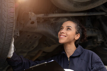 Happiness American Black woman worker. Mechanic lady staff checking car working in auto garage.