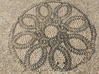 Mosaic of stones in the form of a flower near the Church of St. Nicholas the Wonderworker.