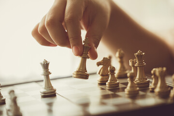 closeup hand playing chess moving chesspiece step forward