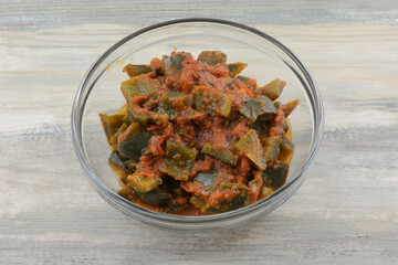 Poblano pepper and tomato chili topping sauce in glass ingredient bowl