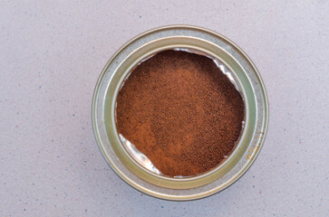 metal can with instant coffee on the table, top view