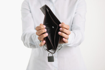 An empty black wallet in chained hands, close-up