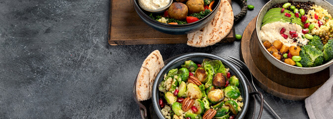 Brussel sprout salad with bulgur on dark background.