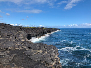ocean waves meeting the rocky island shore