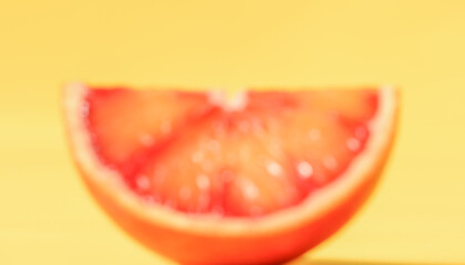 Orange slice blurry photo on yellow background. Fourth photo in the set