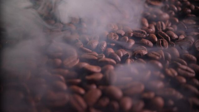 Aromatic coffee beans in the roasting process with the presence of a small amount of smoke. slow movement of the chamber along the surface