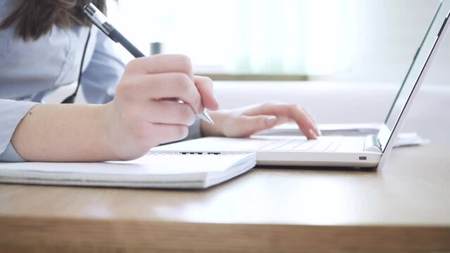 Close up image female hands typing on laptop keyboard
