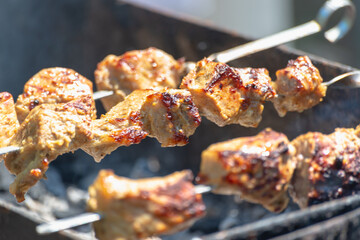 Cooking meat on the street. Shish kebab is fried on a fire and coals.