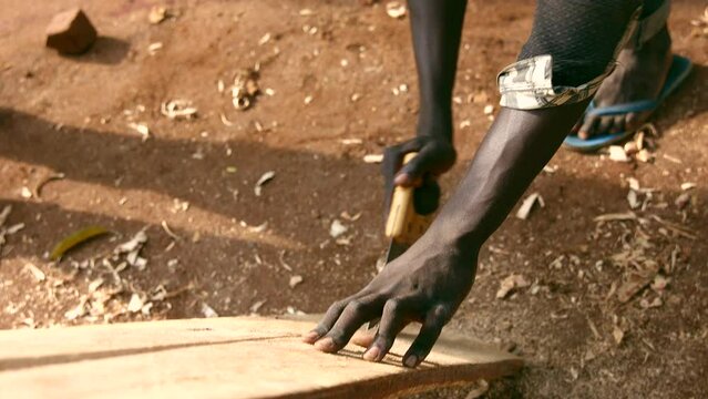 Carpenter varnishing wood in uganda in africa
