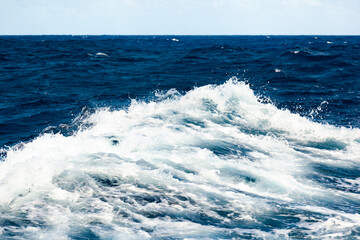 Heavy storm in the ocean. Large waves in the open sea and cloudy sky during a storm.