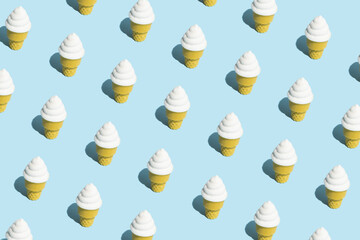 Trendy sunlight Summer pattern made with vannila ice cream on bright light blue background. Minimal summer concept.