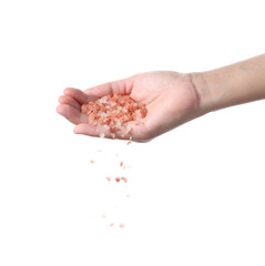 Hand sprinkle pink salt on white background