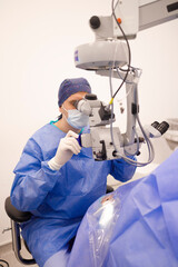 Doctor using surgical microscope during his operation on his patient
