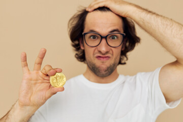 Attractive man with glasses gold bitcoin in hands Lifestyle unaltered