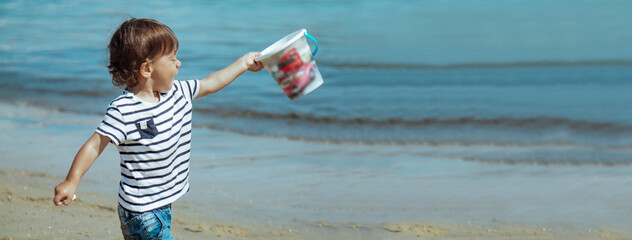 child playing on the beach with copy space