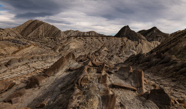 Landscape of dragon tail in Tabernas Desert, Almeria, Spain, against cloudy sky