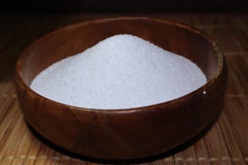Lemon acid. Food cooking E330 is piled into a wooden plate