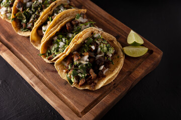Tacos de Suadero. Fried meat in a corn tortilla. Street food from CDMX, Mexico, traditionally accompanied with cilantro, onion and spicy red sauce