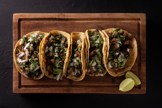 Tacos de Suadero. Fried meat in a corn tortilla. Street food from CDMX, Mexico, traditionally accompanied with cilantro, onion and spicy red sauce