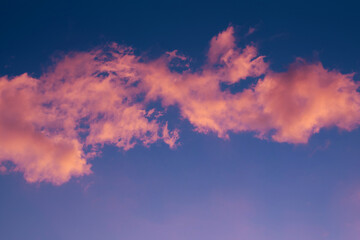 Fototapeta na wymiar pink clouds on the blue sky background