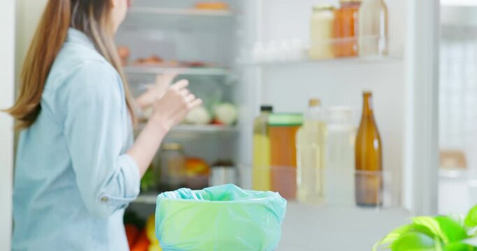 woman is pouring food waste