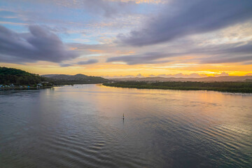Sunrise waterscape with a mix of low, medium and high clouds