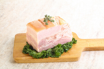 Cut of pork bacon over board