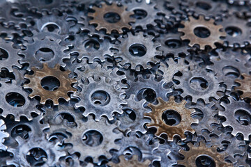 Lots of new steel gears in oil close-up.