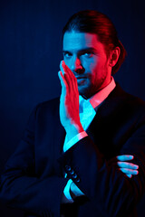 handsome man gestures with his hands attractive look neon light