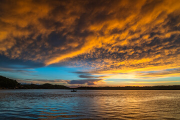 Sunrise by the bay with cumulonimbus clouds