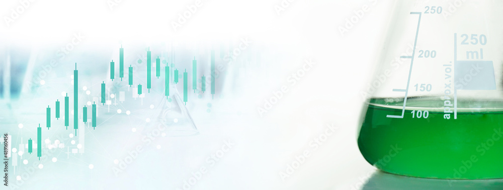 Wall mural glass flask with green solution with data in science education lab on white background