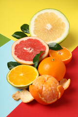 Different citrus fruits on multi color background