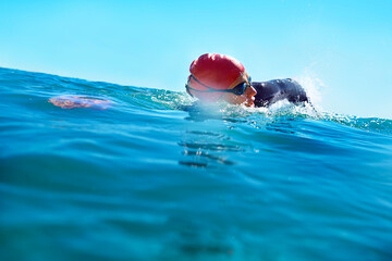 Fototapeta premium Training wherever theres water. Shot of a swimmer in the open ocean.