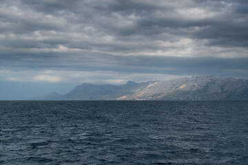 Fototapeta na wymiar Mountain coast and Adriatic Sea in Croatia during a cloudy day