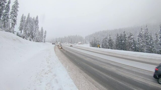 Winter Weather in the Mountains with Snow Falling on Washington State Highway 2