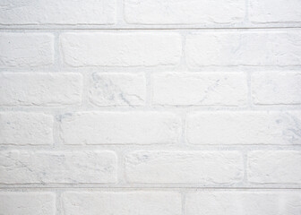 The modern texture of a white brick wall can be used as a background or a sample for a design.