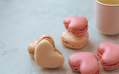 Macaron cake or heart shaped macaroons on a gray background, colorful macaroons, pastel colors with copy space