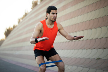 Young sexy man training outside. Fit handsome man doing exercise