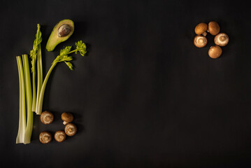 Green healthy vegetables and fruits on a black background. Green products on a dark background. 