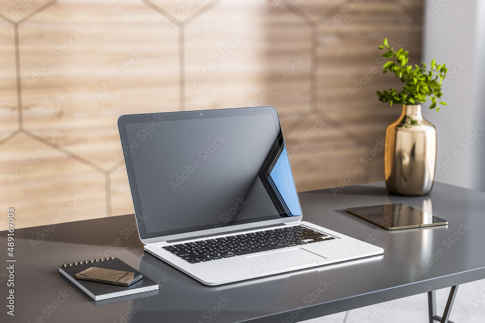 Poster closeup of modern laptop with smartphone, digital tablet and bronze color vase on dark glossy table 