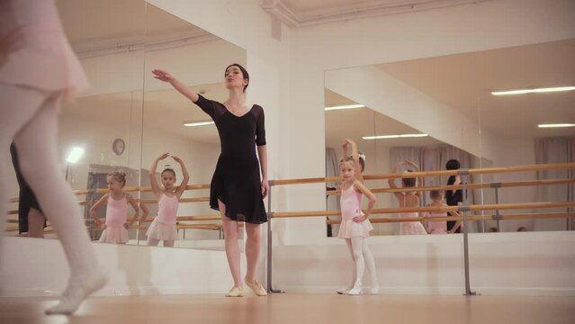 Ballet training - three little girls on ballet training with their trainer
